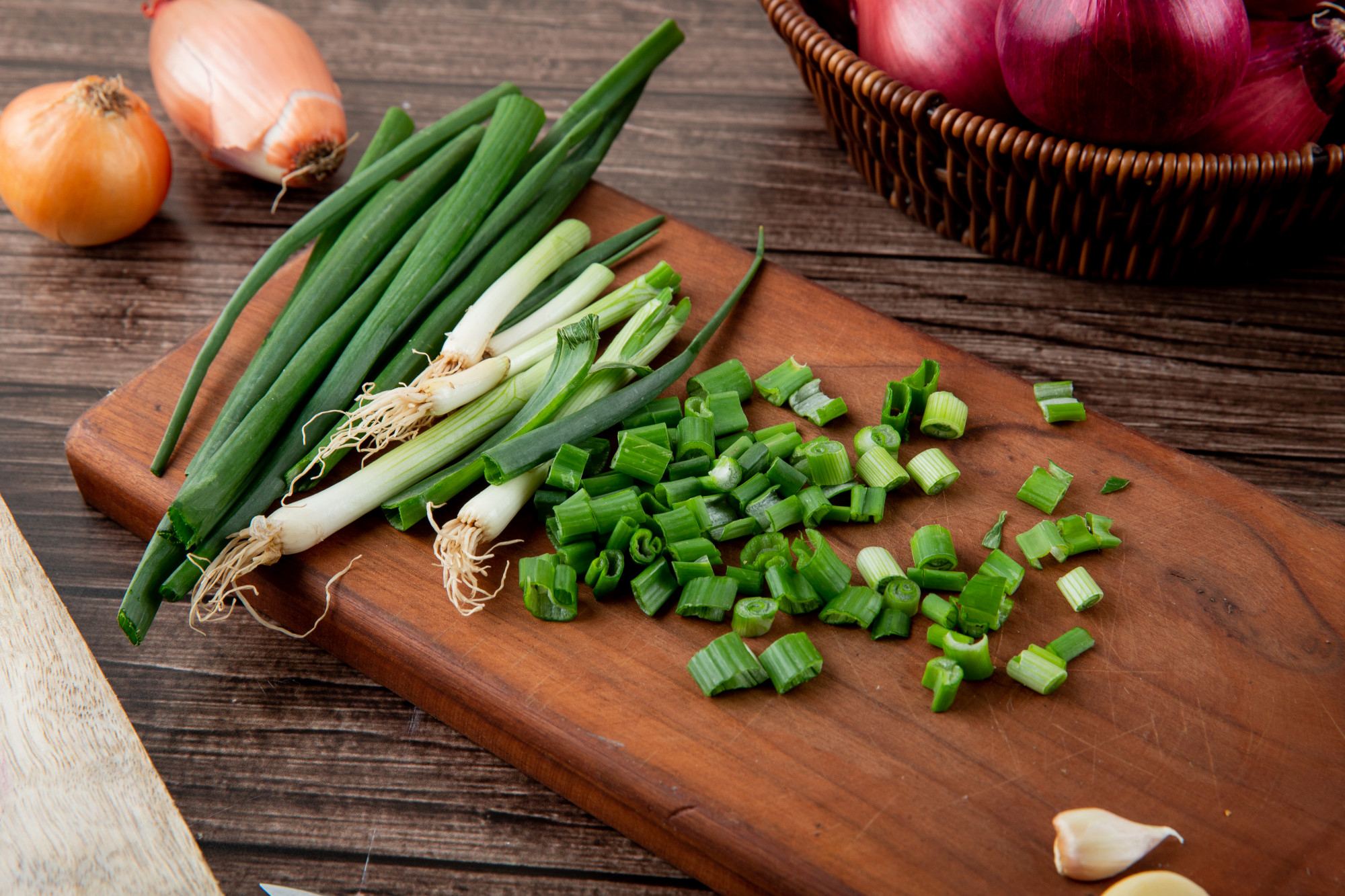 close up view cut green onion wooden surface wooden background